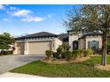 Beautiful single-story home with a paved driveway and a lush, well manicured lawn at 833 Honeyflower Loop, Bradenton, FL 34212