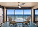 Enjoy ocean views from this cozy balcony with seating, a perfect spot to relax and enjoy the scenery at 900 Gulf Blvd # 805, Indian Rocks Beach, FL 33785