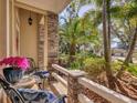 Inviting front porch with comfortable seating, stone columns, and a view of the manicured landscaping at 13811 Nighthawk Ter, Lakewood Ranch, FL 34202