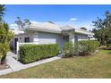 Charming single-story home with a tidy front yard and manicured hedges creating a welcoming entrance at 276 Cerromar Way # 60, Venice, FL 34293