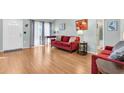 Bright living room featuring wood floors, a cozy sofa, and natural light at 3403 36Th W St # 109, Bradenton, FL 34205