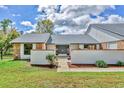 Charming single-story home featuring a manicured lawn, brick accents, and a welcoming double-door entrance at 3651 Walden Pond Dr, Sarasota, FL 34240
