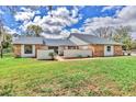 Inviting single-story home with lush green lawn and brick accents on a sunny day at 3651 Walden Pond Dr, Sarasota, FL 34240