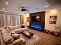 Modern living room with a fireplace and hardwood floors throughout at 4396 Everglades Ter, North Port, FL 34286