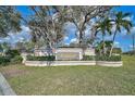 Entrance to the Southfield community featuring manicured lawns, colorful shrubbery and mature trees at 4639 Meadowview Cir, Sarasota, FL 34233