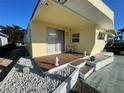 Inviting porch area with wooden deck, outdoor seating, and decorative accents against yellow siding at 5319 Chateau Ln, Bradenton, FL 34207