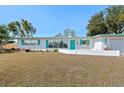 Inviting single-level home with a tidy front yard, turquoise shutters, and a bright, welcoming entrance at 5724 25Th W St, Bradenton, FL 34207