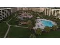 Aerial view of the condo community with swimming pool and pond at 5780 Midnight Pass Rd # 303B, Sarasota, FL 34242