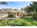 Inviting single story home with brick accents, mature landscaping, and a tile roof at 1612 Pine Harrier Cir, Sarasota, FL 34231