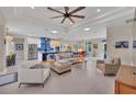Bright open-plan living room boasts lots of natural light, tray ceilings, and modern decor at 3301 River Woods Dr, Parrish, FL 34219