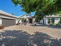 Beautiful home with a paver driveway, a two car garage, and manicured landscaping, exuding curb appeal and charm at 355 W Royal Flamingo Dr, Sarasota, FL 34236