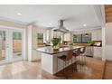 Modern kitchen with a center island, stainless steel appliances, and stylish bar stool seating at 4931 Hidden Oaks Trl, Sarasota, FL 34232