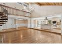 Bright living room with vaulted ceilings, hardwood floors, spiral staircase, and an open floor plan at 4931 Hidden Oaks Trl, Sarasota, FL 34232
