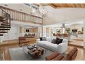 Bright living room with vaulted ceilings, hardwood floors, spiral staircase, and an open floor plan at 4931 Hidden Oaks Trl, Sarasota, FL 34232
