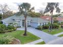 A home featuring a paver driveway and immaculate landscaping, creating an inviting curb appeal at 6612 Saint James Xing, University Park, FL 34201