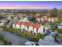 Aerial view highlights the condos, swimming pool, and tropical landscaping of this beachfront community at 6790 Sarasea Cir # 6790, Sarasota, FL 34242