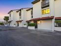 A townhome exterior with garages and tidy landscaping, and a row of individual front entrances at 6790 Sarasea Cir # 6790, Sarasota, FL 34242