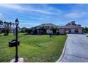 Charming single-story home featuring a well-manicured lawn, palm trees, and an inviting front entrance at 2002 Palm View Rd, Sarasota, FL 34240