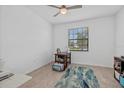 Cozy bedroom with neutral walls, tile floors, and a window offering natural light at 2081 Gardenia Ave, Port Charlotte, FL 33953