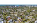 Expansive aerial view of a charming home nestled in a lush, green neighborhood near a vibrant cityscape at 2377 Burton Ln, Sarasota, FL 34239