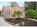 Charming single-story home featuring a well-manicured lawn, a quaint walkway, and a light teal entry door at 2524 11Th W Ave, Bradenton, FL 34205