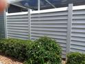 Horizontal slat fence provides privacy and defines the backyard landscape at 3300 Loveland Blvd # 3203, Punta Gorda, FL 33980