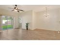 Bright, open living room featuring modern floors, ceiling fan, and a sliding door to the outside at 3823 Parkridge Cir # 1-101, Sarasota, FL 34243
