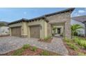 Charming single-Gathering home featuring a two-car garage and an arched entry over a beautifully paved driveway at 428 Bocelli Dr, North Venice, FL 34275