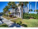 Townhome featuring a well-manicured lawn, walkway, and mature palm trees along the front at 4717 Sabal Key Dr, Bradenton, FL 34203