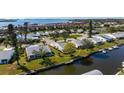 Aerial view of home with canal access, dock, and well-manicured lawn at 4721 Mount Vernon Dr, Bradenton, FL 34210