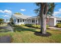 Charming single-story home with a well-maintained lawn, mature tree, and lovely landscaping at 4721 Mount Vernon Dr, Bradenton, FL 34210
