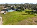Vast lawn area with a view of the pond, pool, and the house, perfect for outdoor enjoyment at 1228 Wagon Wheel Dr, Sarasota, FL 34240