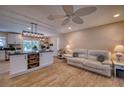 Open concept living and kitchen area with island, modern lighting, and inviting seating area at 13575 Martha Ave, Port Charlotte, FL 33981