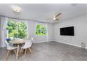 Open living room featuring tile floors, recessed lighting, ceiling fan, and sliding door to outdoor patio at 17136 Blowfish Dr, Nokomis, FL 34275
