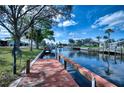 Scenic canal view from the end of the private dock, perfect for boating and enjoying waterfront living at 18576 Alphonse Cir, Port Charlotte, FL 33948