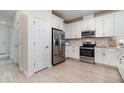 Modern kitchen featuring stainless steel appliances, stylish cabinets, and a tile backsplash at 1944 Vang Ln, Sarasota, FL 34240
