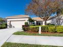 Charming single-story home with a tile roof, well-maintained landscaping, and an attached two-car garage at 4155 Cascade Falls Dr, Sarasota, FL 34243