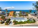 Stunning beachfront homes with colorful exteriors and beautiful landscaping with ocean views at 912 N Shore Dr, Anna Maria, FL 34216