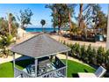 Beautiful gazebo featuring outdoor seating with ocean view in the background at 912 N Shore Dr, Anna Maria, FL 34216