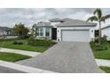 Lovely single-story home with a two-car garage, well-kept lawn, and attractive landscaping at 9978 Bright Water Drive, Englewood, FL 34223