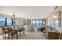 Open living space with ocean views, chandelier, and neutral tones create a relaxed atmosphere at 2675 Gulf Of Mexico Dr # 301, Longboat Key, FL 34228