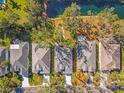 An aerial view showcases a row of well-maintained homes lining a serene lakefront property at 28 Tall Trees Ct, Sarasota, FL 34232