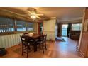 Inviting dining room with windows, wood floors and ceiling fan at 3054 Mancini Ter, Punta Gorda, FL 33983