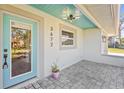 Inviting front entrance with blue door, gray brick, and overhead light fixture at 3672 Pine Rd, Venice, FL 34293