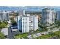 An aerial view showcases the condominium’s beautiful landscaping, pool, parking, and nearby residences at 435 S Gulfstream Ave # 804, Sarasota, FL 34236