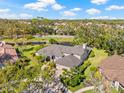 Expansive estate with lush landscaping, mature trees, and a serene pond view at 4477 White Cedar Trl, Sarasota, FL 34238