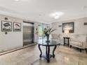 Welcoming lobby featuring travertine floors, seating area, and elevator access for added convenience at 5246 Manorwood Dr # 4, Sarasota, FL 34235