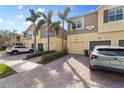 Townhome with a paver driveway, one car garage and two stories with palm trees at 5435 Soapstone Place # 22-103, Sarasota, FL 34233