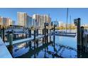 Boat dock in a marina with modern buildings in the background, and a sunny day at 650 Golden Gate Pt # 403, Sarasota, FL 34236