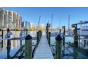 Wooden dock with cityscape views and boat lift in a marina setting at 650 Golden Gate Pt # 403, Sarasota, FL 34236